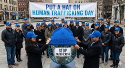 group of people putting a hat on a metal mesh world